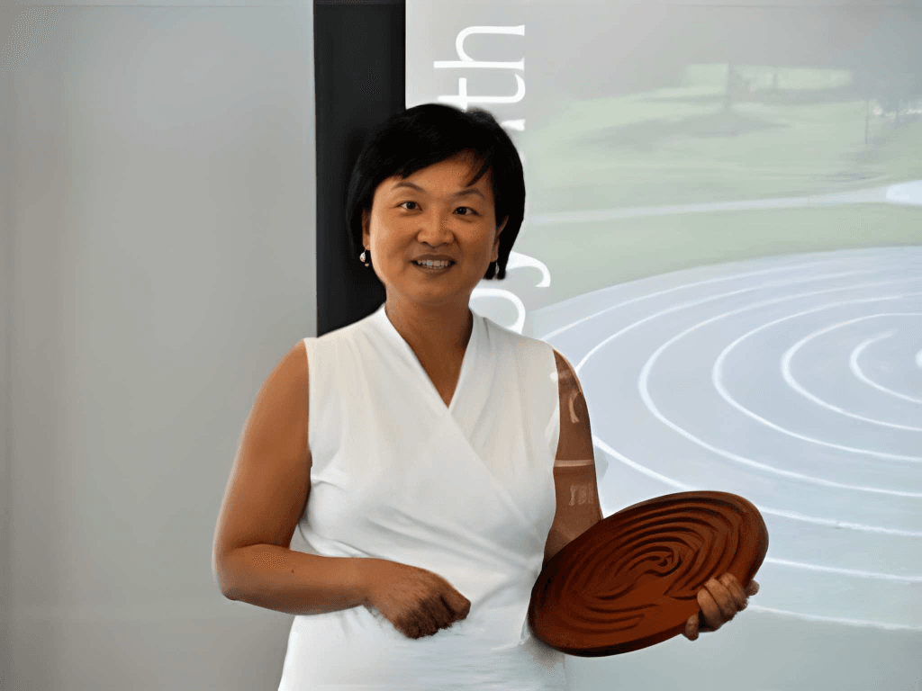 Diana holding a finger labyrinth during a presentation